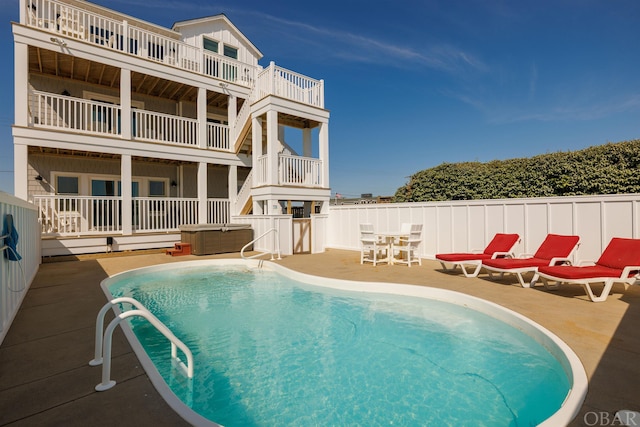 view of swimming pool featuring fence, a fenced in pool, and a patio