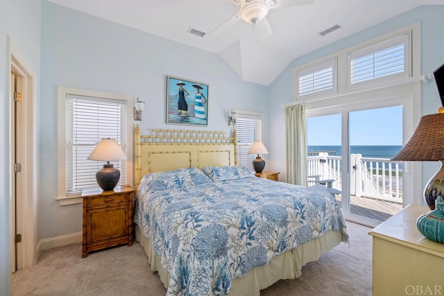 bedroom featuring vaulted ceiling, light colored carpet, visible vents, and access to exterior