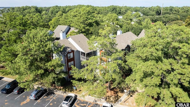 drone / aerial view with a wooded view