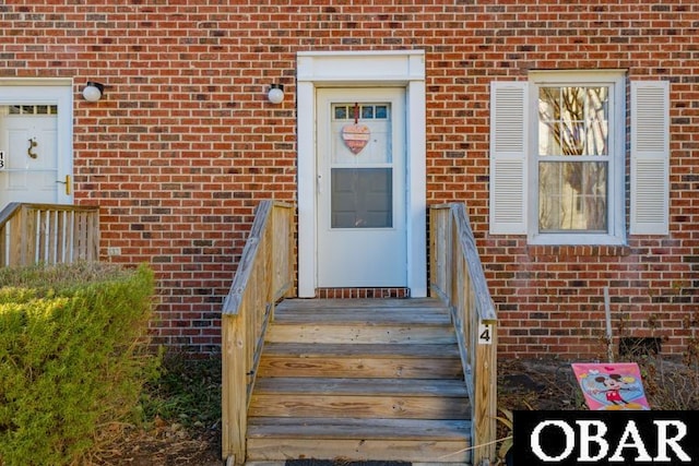 view of exterior entry with brick siding