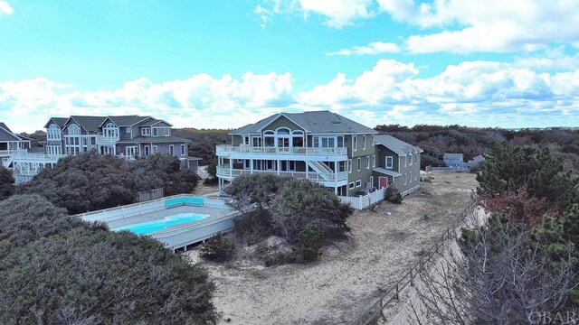 back of house featuring a balcony