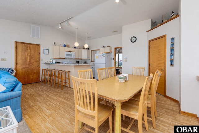 8415 S Old Oregon Inlet Rd Lot, Lot, Nags Head, NC 27959 - dining room featuring lofted ceiling, light wood finished floors, and rail lighting
