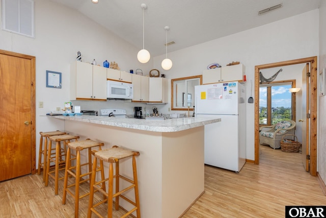 8415 S Old Oregon Inlet Rd Lot, Lot, Nags Head, NC 27959 - kitchen with white appliances, high vaulted ceiling, a peninsula, light wood-style floors, and a kitchen breakfast bar