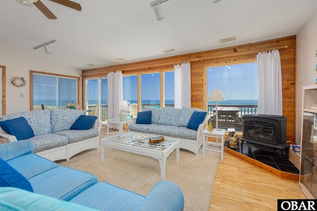 8415 S Old Oregon Inlet Rd Lot, Lot, Nags Head, NC 27959 - living area with a wood stove, rail lighting, ceiling fan, a textured ceiling, and wood finished floors