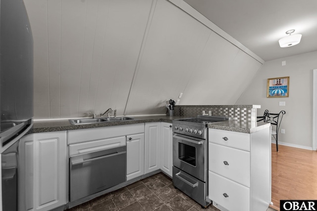 118 W Soundside Rd Lot Pt7, Nags Head, NC 27959 - kitchen with a sink, appliances with stainless steel finishes, white cabinetry, and dark countertops