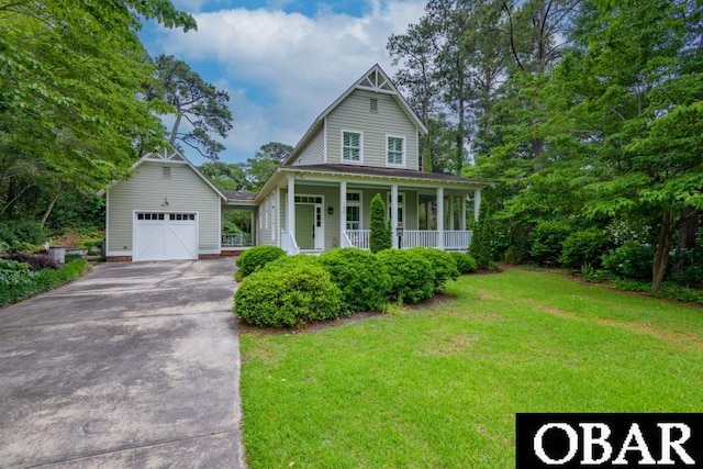 102 William And Mary Way Lot 13, Manteo, NC 27954 - view of front of home with a garage, a porch, a front lawn, and concrete driveway