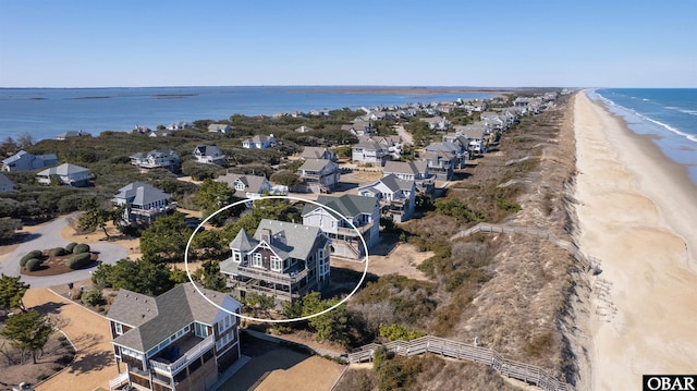 birds eye view of property with a beach view and a water view