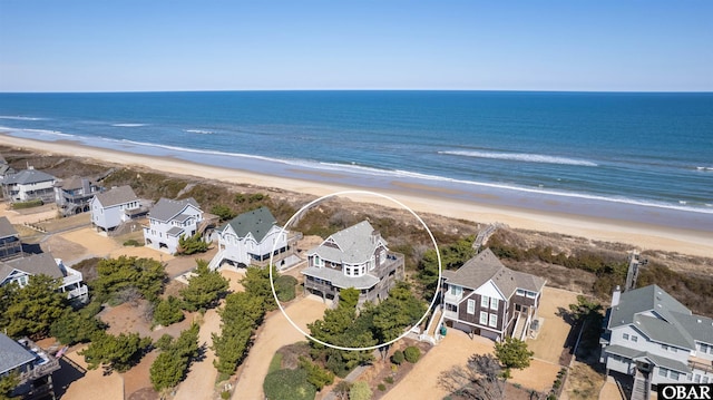 birds eye view of property featuring a residential view, a water view, and a beach view