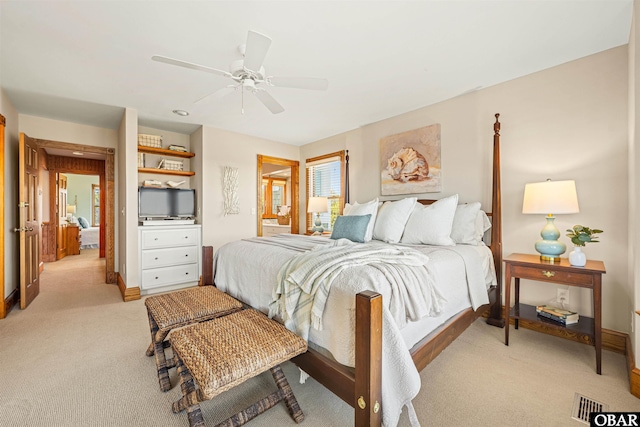 bedroom featuring a ceiling fan, light carpet, and baseboards