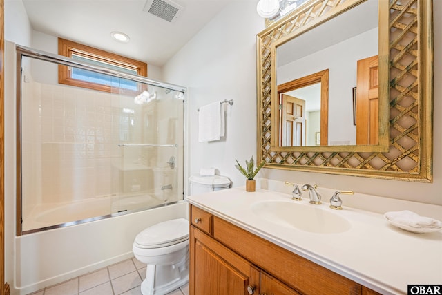 full bath featuring bath / shower combo with glass door, visible vents, toilet, vanity, and tile patterned floors