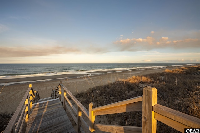 view of community with a water view and a beach view