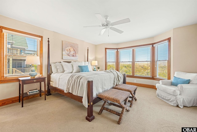 bedroom featuring light carpet, ceiling fan, and baseboards