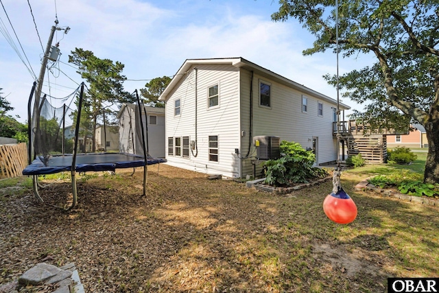 2908 S Meekins Ave Lot 9, Nags Head, NC 27959 - back of house featuring a trampoline, stairway, cooling unit, and a deck