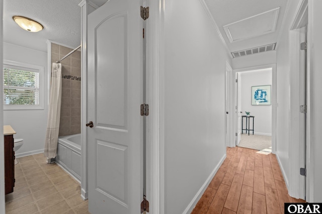 2908 S Meekins Ave Lot 9, Nags Head, NC 27959 - corridor featuring attic access, baseboards, a textured ceiling, and light wood-type flooring