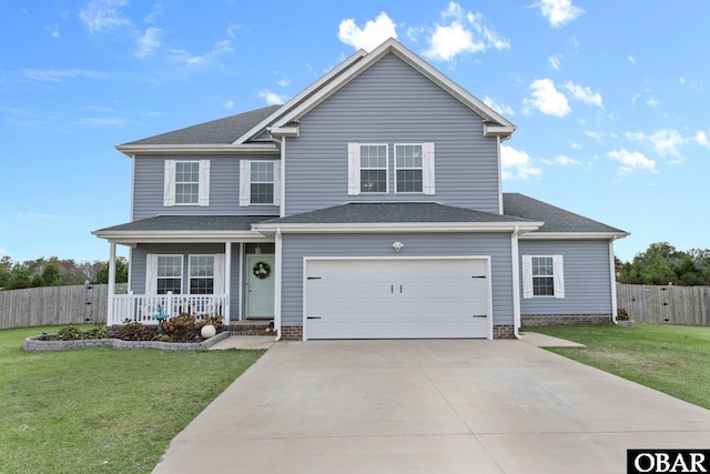 traditional home with a front yard, a porch, an attached garage, and fence