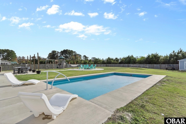 view of pool with a lawn, playground community, a fenced in pool, and a fenced backyard