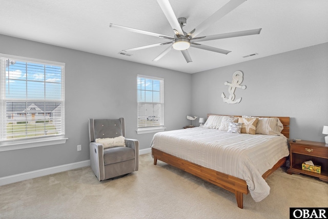 bedroom with baseboards, visible vents, and light carpet
