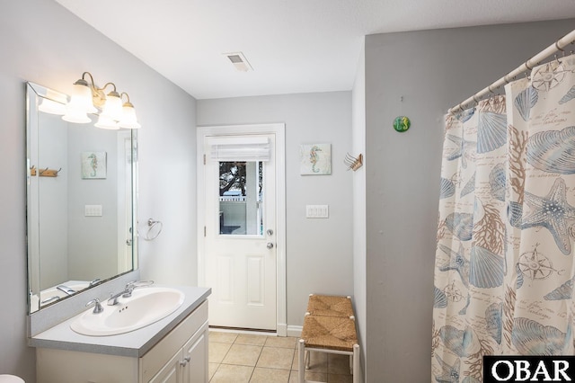 bathroom with vanity, a shower with shower curtain, tile patterned flooring, and visible vents