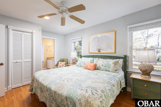 bedroom featuring connected bathroom, a closet, a ceiling fan, and wood finished floors