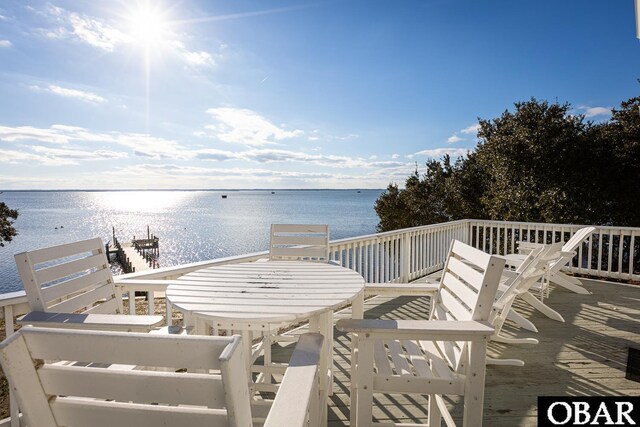 wooden terrace featuring a water view