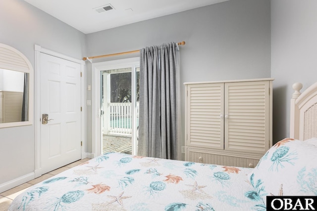 bedroom featuring access to outside, visible vents, baseboards, and light tile patterned flooring