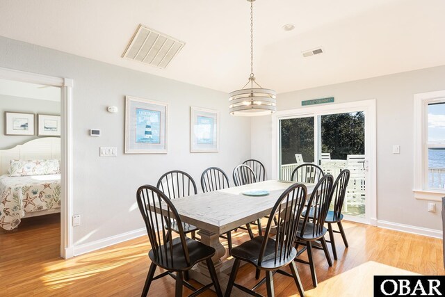 dining area featuring baseboards, visible vents, and light wood-style floors