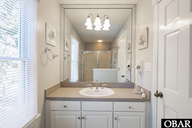 bathroom featuring a shower stall, visible vents, and vanity