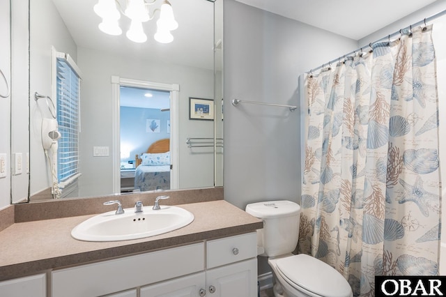 bathroom with ensuite bathroom, a chandelier, curtained shower, toilet, and vanity