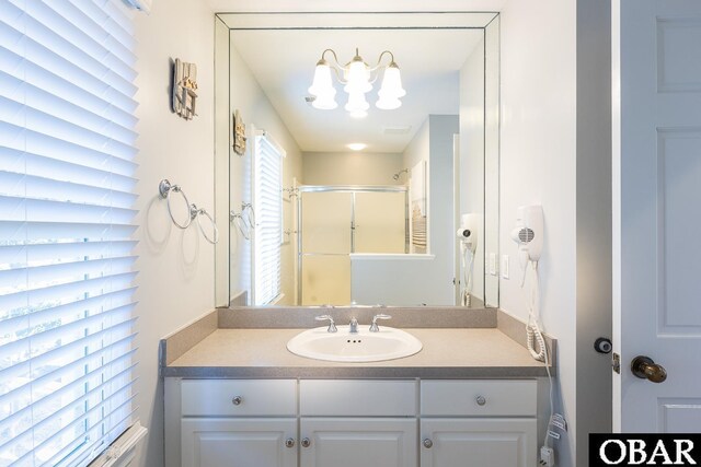 bathroom with a stall shower and vanity