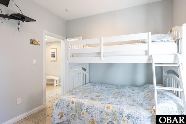 bedroom with baseboards and light tile patterned floors