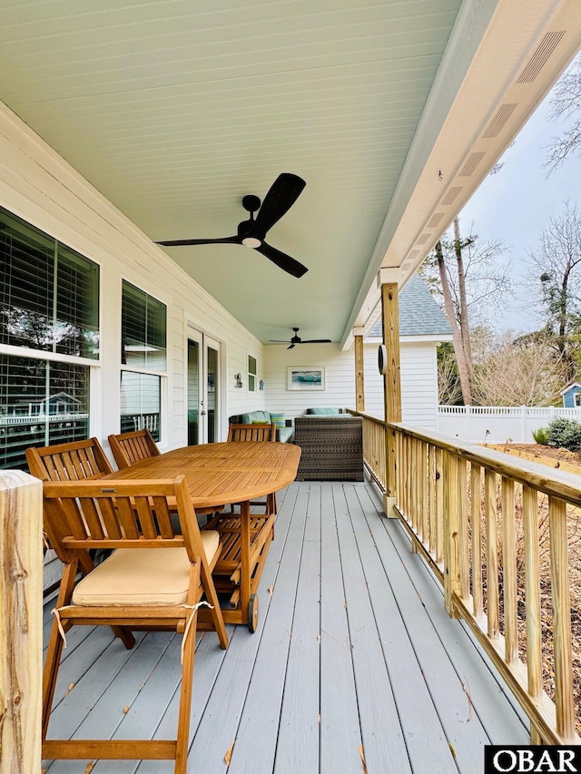 wooden deck with a ceiling fan, outdoor dining space, and fence