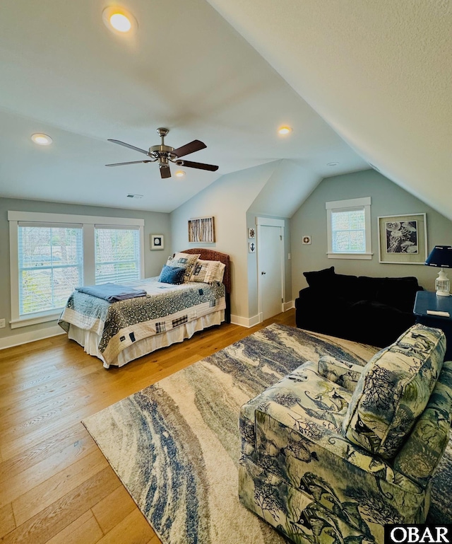 bedroom with a ceiling fan, vaulted ceiling, wood finished floors, and recessed lighting