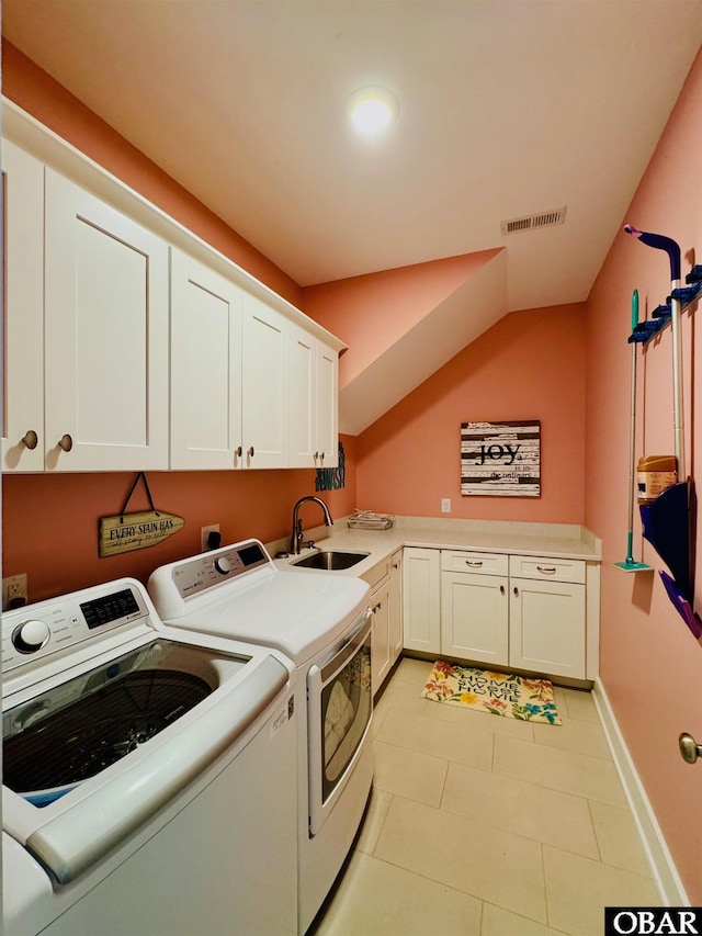 laundry area with cabinet space, visible vents, baseboards, washer and dryer, and a sink