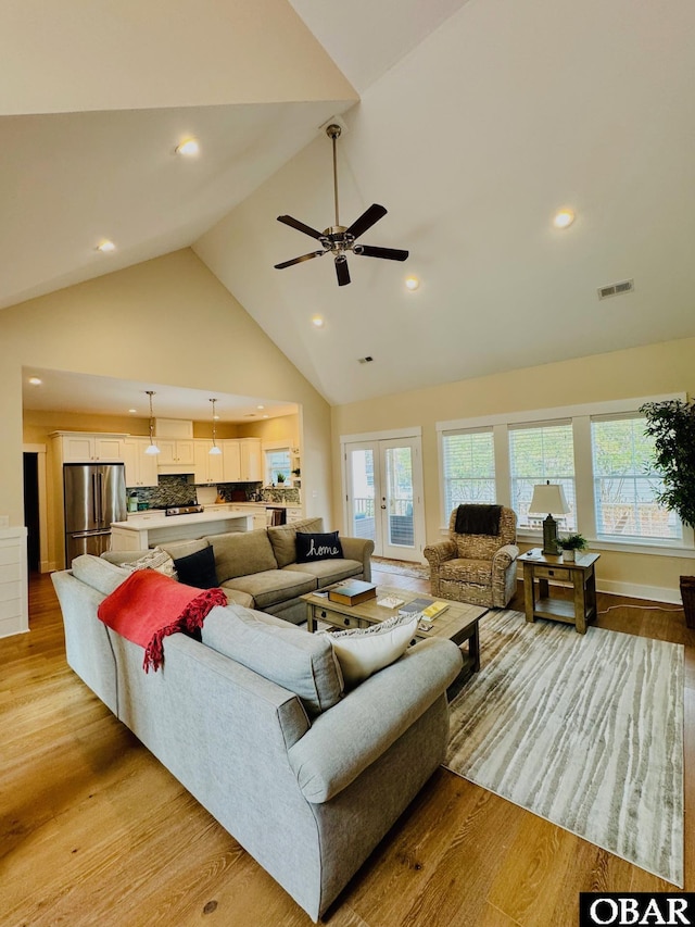 living room featuring a healthy amount of sunlight, light wood-style flooring, and visible vents