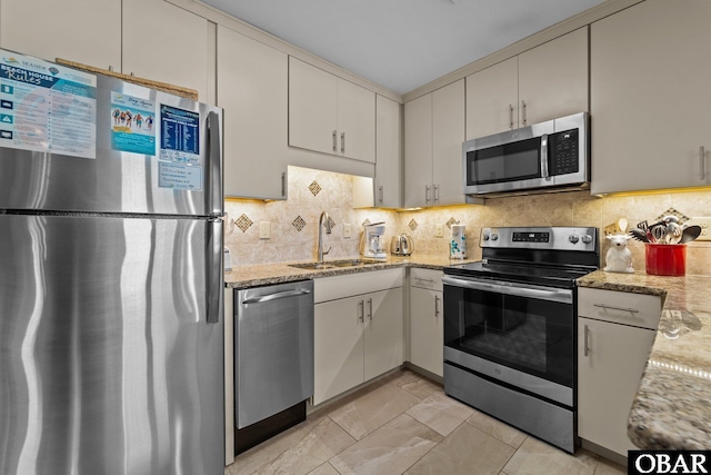 2035 S Virginia Dare Trl Unit 7, Kill Devil Hills, NC 27948 - kitchen featuring stainless steel appliances, a sink, tasteful backsplash, and light stone counters