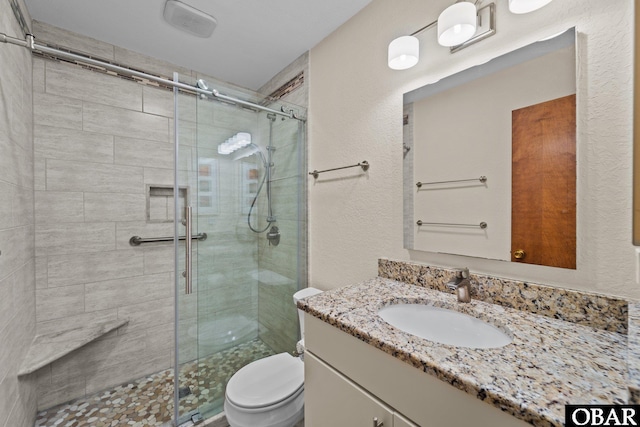 2035 S Virginia Dare Trl Unit 7, Kill Devil Hills, NC 27948 - full bath with vanity, a stall shower, toilet, and a textured wall