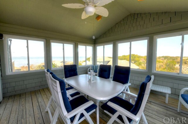 sunroom / solarium with a water view, a ceiling fan, and lofted ceiling