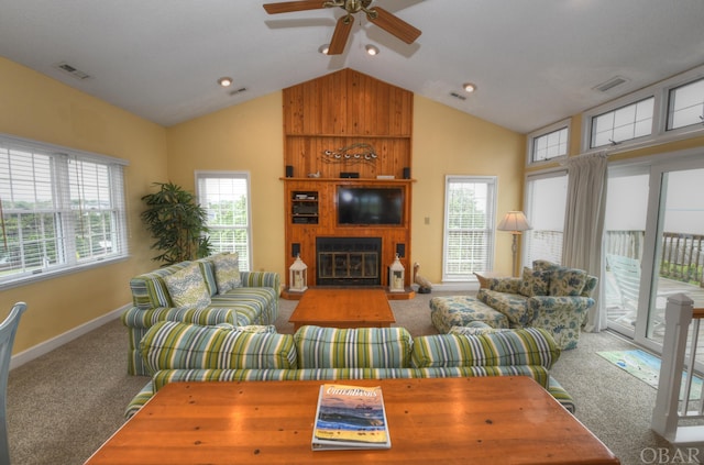 living room featuring a large fireplace, carpet, and visible vents