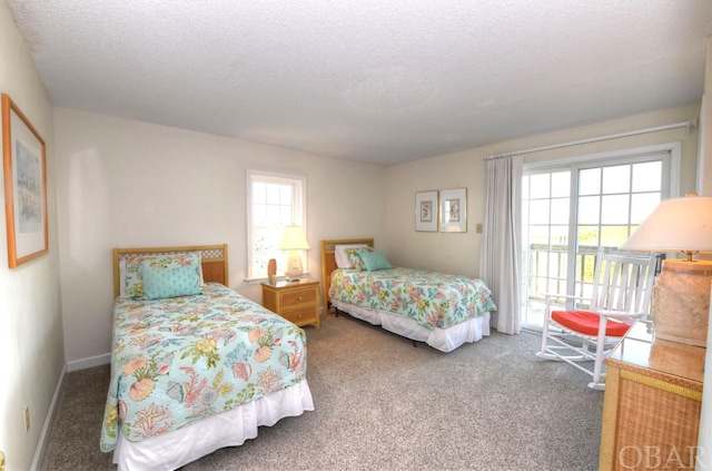 carpeted bedroom with access to outside and a textured ceiling