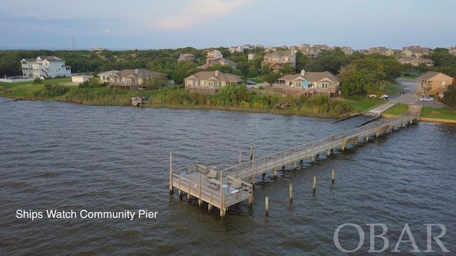 view of dock with a water view and a residential view