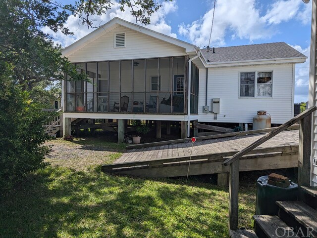 369 Lighthouse Rd Lot # 2, Ocracoke, NC 27960 - rear view of house with a shingled roof, a lawn, and a sunroom