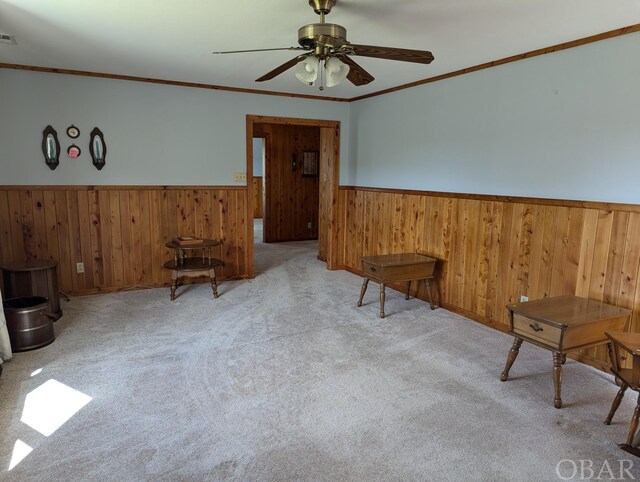 369 Lighthouse Rd Lot # 2, Ocracoke, NC 27960 - unfurnished room with light carpet, visible vents, a wainscoted wall, ceiling fan, and ornamental molding
