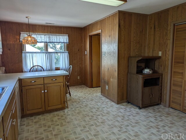 369 Lighthouse Rd Lot # 2, Ocracoke, NC 27960 - kitchen with wooden walls, visible vents, light countertops, brown cabinetry, and pendant lighting
