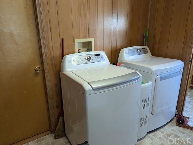 369 Lighthouse Rd Lot # 2, Ocracoke, NC 27960 - laundry room featuring laundry area, wooden walls, and washing machine and clothes dryer