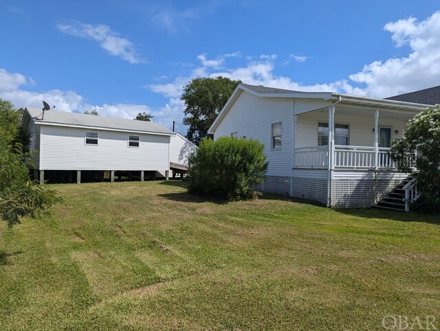369 Lighthouse Rd Lot # 2, Ocracoke, NC 27960 - view of home's exterior featuring a porch and a yard