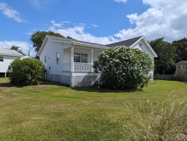 369 Lighthouse Rd Lot # 2, Ocracoke, NC 27960 - view of property exterior with covered porch and a yard