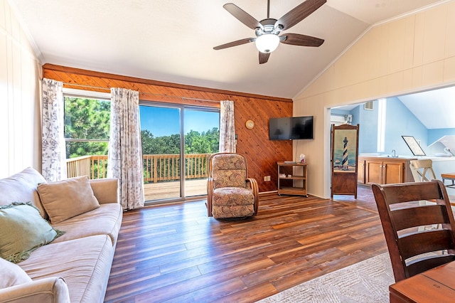 living room featuring ceiling fan, vaulted ceiling, wood walls, and wood finished floors