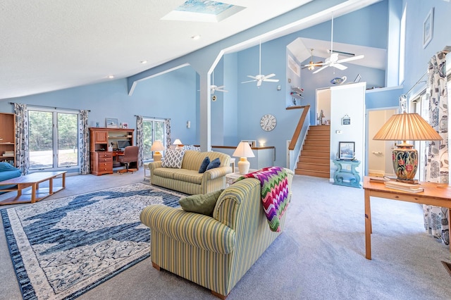 living room featuring a textured ceiling, stairway, a skylight, and carpet flooring