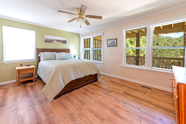 bedroom featuring light wood-style floors, visible vents, baseboards, and a ceiling fan