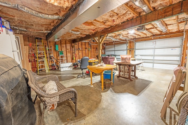 garage with freestanding refrigerator and a garage door opener